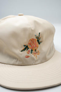 100% nylon hat with an embroidered rose on the front and "The Athletic" embroidered in the back