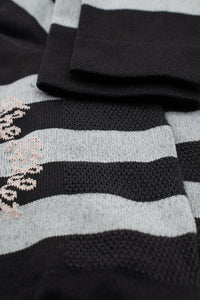 black and grey striped socks with a palm on either side of the sock