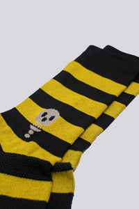 black and yellow striped socks with a skull on either side of the sock