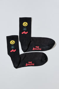 off white socks with a smiley face, cactus and squiggle