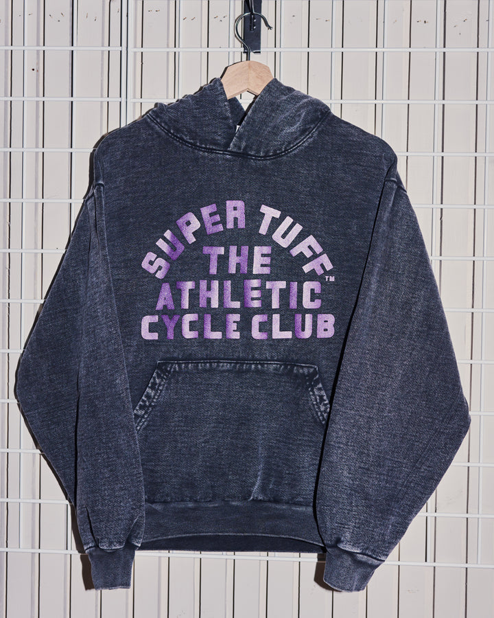 Black hoodie with 'Super Tuff The Athletic Cycle Club' text on a tiled wall background