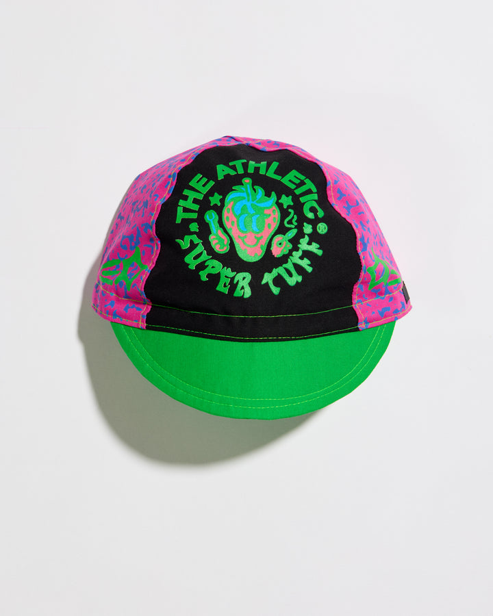 The Athletic Super Tuff Strawberry Cycling Cap is a vibrant, unstructured 3-panel cap featuring a bold strawberry design. Crafted in the Portland, OR, by Double Darn, this cap offers a comfortable fit.