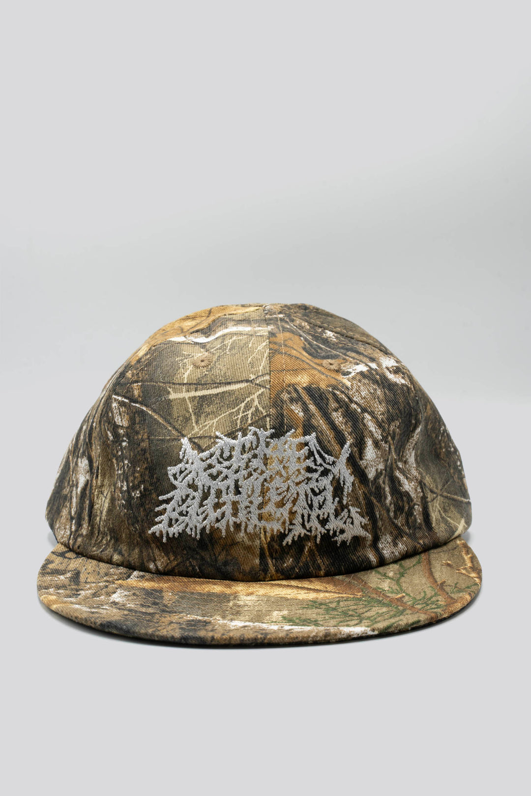 The Realtree Realness Cap is a versatile, unstructured 6-panel hat featuring a unique camo pattern that varies slightly with each cap, adding individuality to your gear. Designed in collaboration with Kyle Kelley, it includes a soft, regular-length bill and no top button, ensuring comfort under a helmet. Crafted in the USA, this hat is perfect for everyday wear and is easily packable for on-the-go adventures