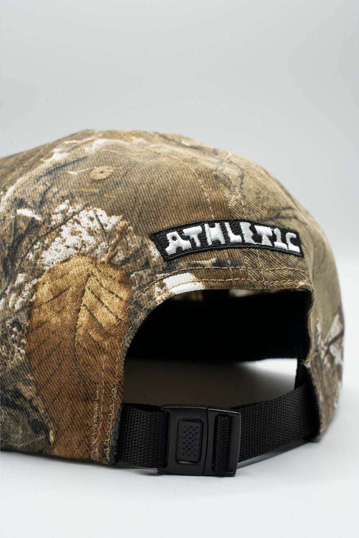 The Realtree Realness Cap is a versatile, unstructured 6-panel hat featuring a unique camo pattern that varies slightly with each cap, adding individuality to your gear. Designed in collaboration with Kyle Kelley, it includes a soft, regular-length bill and no top button, ensuring comfort under a helmet. Crafted in the USA, this hat is perfect for everyday wear and is easily packable for on-the-go adventures