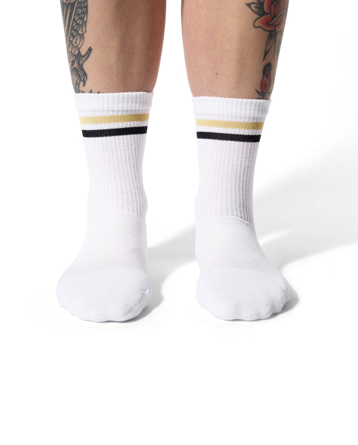 The Tiger Eye Triple Double Crew Socks are designed for versatility and comfort, featuring a fully padded foot and a relaxed ribbed cuff. Ideal for cycling, running, cross-training, or casual wear, these socks are made in the USA from recycled fibers, combining performance with sustainability