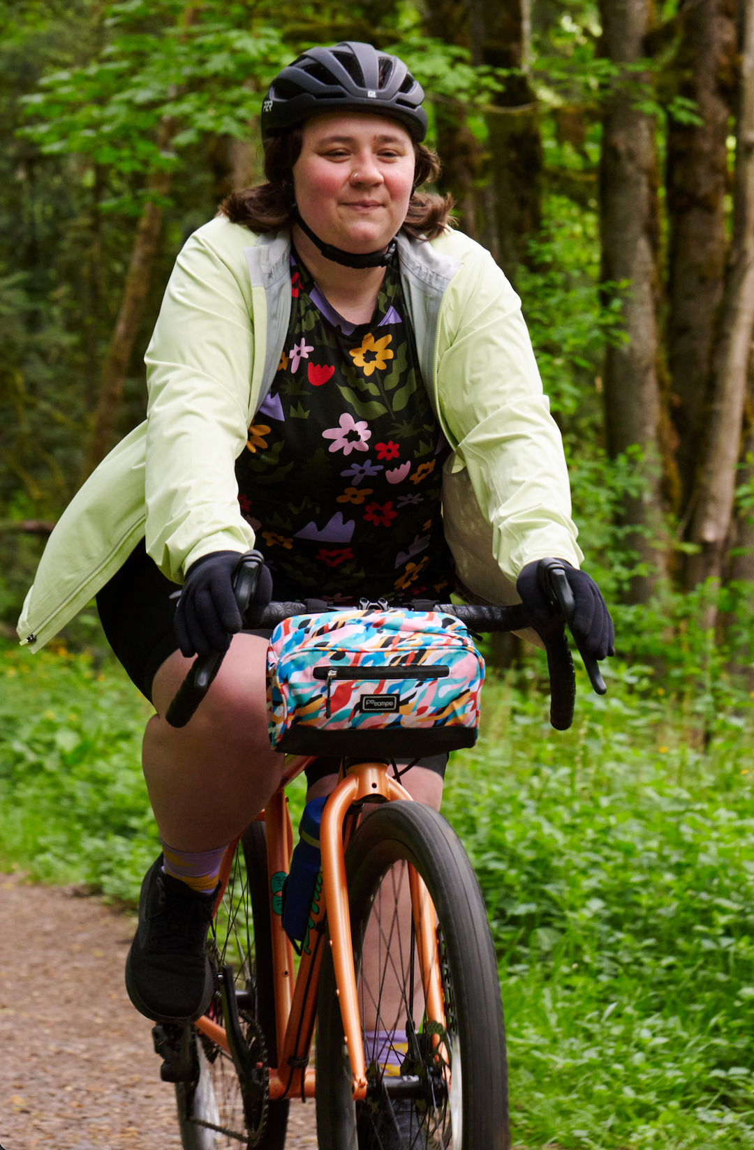 Person riding a bicycle on a trail in a forest