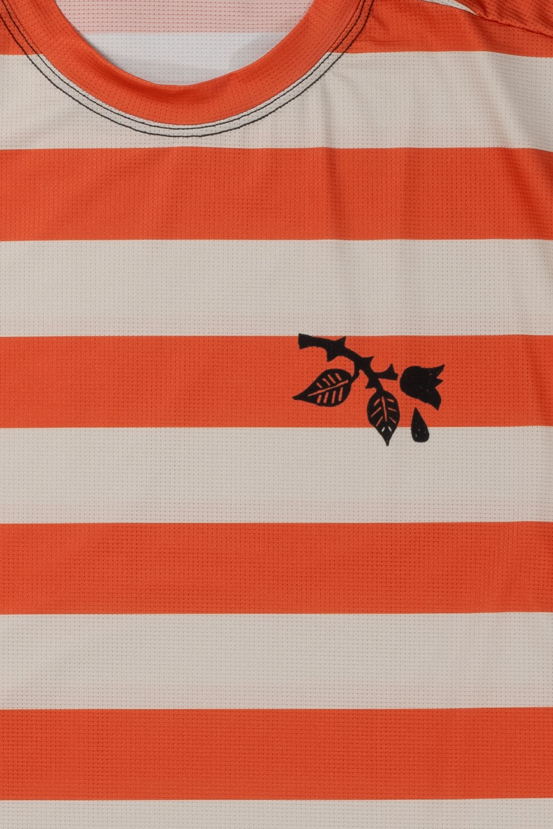 The Men's Waldo Short Sleeve Tech Tee is a versatile performance shirt designed for activities like running, cycling, and cross-training. Crafted in California from Italian-engineered fabrics, it features a lightweight, breathable design with a split side seam at the hem to accommodate lower body movement. This timeless striped tee, adorned with a black rose on the upper left chest, offers both style and functionality for active individuals