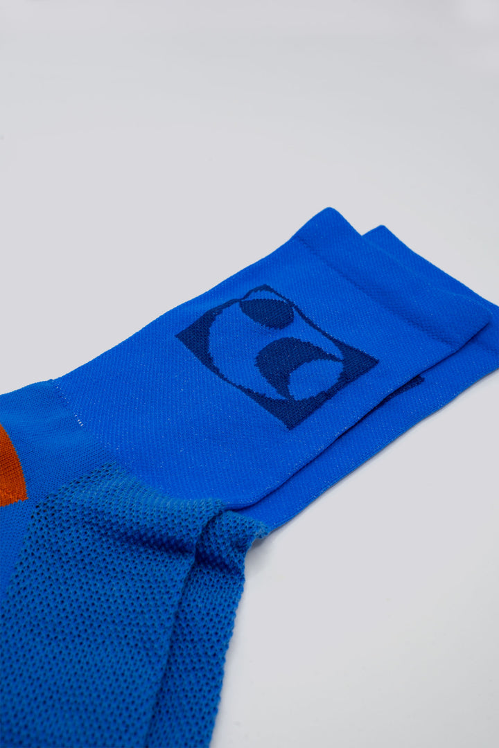 The Moonspin x The Athletic Socks are a collaboration between Moonspin, a women-led mountain biking apparel brand, and The Athletic Community. These socks are available in two colorways: Navy and Blue. Designed to inspire and style your biking adventures, they combine performance with style. Made in the USA with synthetic fibers from post-consumer recycled water bottles, these lightweight socks are breathable, moisture-wicking, and durable—ideal for warm weather cycling and everyday adventures