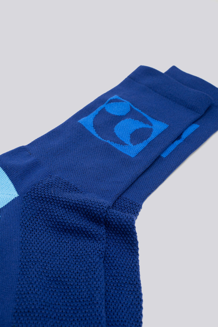 The Moonspin x The Athletic Socks are a collaboration between Moonspin, a women-led mountain biking apparel brand, and The Athletic Community. These socks are available in two colorways: Navy and Blue. Designed to inspire and style your biking adventures, they combine performance with style. Made in the USA with synthetic fibers from post-consumer recycled water bottles, these lightweight socks are breathable, moisture-wicking, and durable—ideal for warm weather cycling and everyday adventures