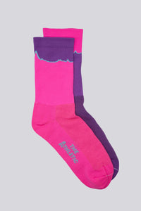 Mismatched socks with teal and purple colors for running or cycling