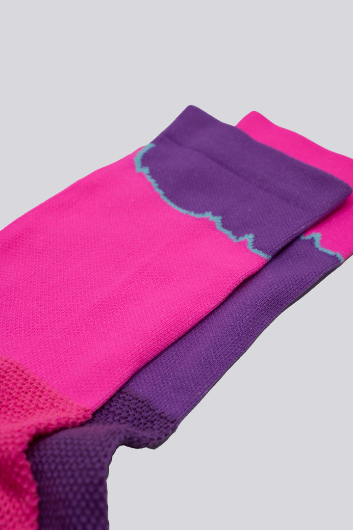 The Elevation Socks – Hood to Coast Edition are designed to commemorate the iconic Hood to Coast Relay, featuring a design that mirrors the elevation profile of the course from Wy'East to the Pacific Ocean. These socks are crafted for versatility, suitable for running, walking, hiking, or cycling. They offer a medium compression cuff for support and are made from a blend of 60% nylon, 39% recycled polyester, and 1% Lycra, ensuring both comfort and durability. Machine washable for easy care