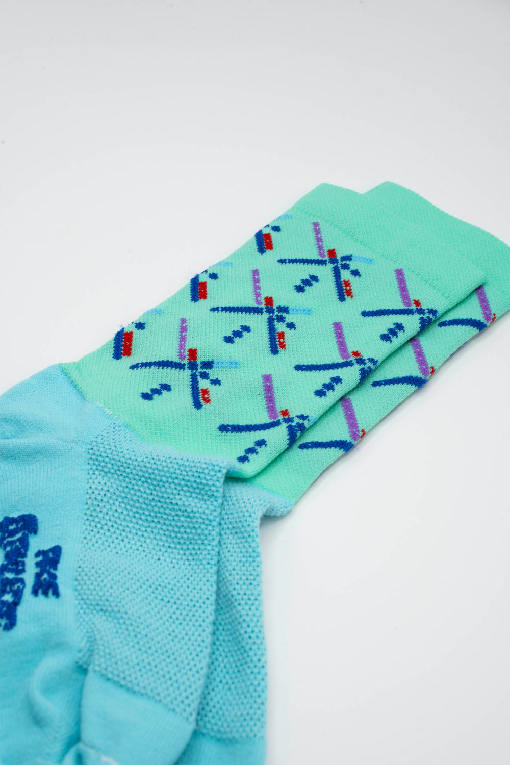 The Kid Size - The Athletic PDX Airport Carpet Sock is a youth-sized version of the iconic Portland Airport carpet design, featuring a 5" cuff for a comfortable fit. Crafted with a medium compression cuff, these socks are perfect for cycling, running, and cross-training. Made in the USA with recycled fibers, they combine style, performance, and sustainability