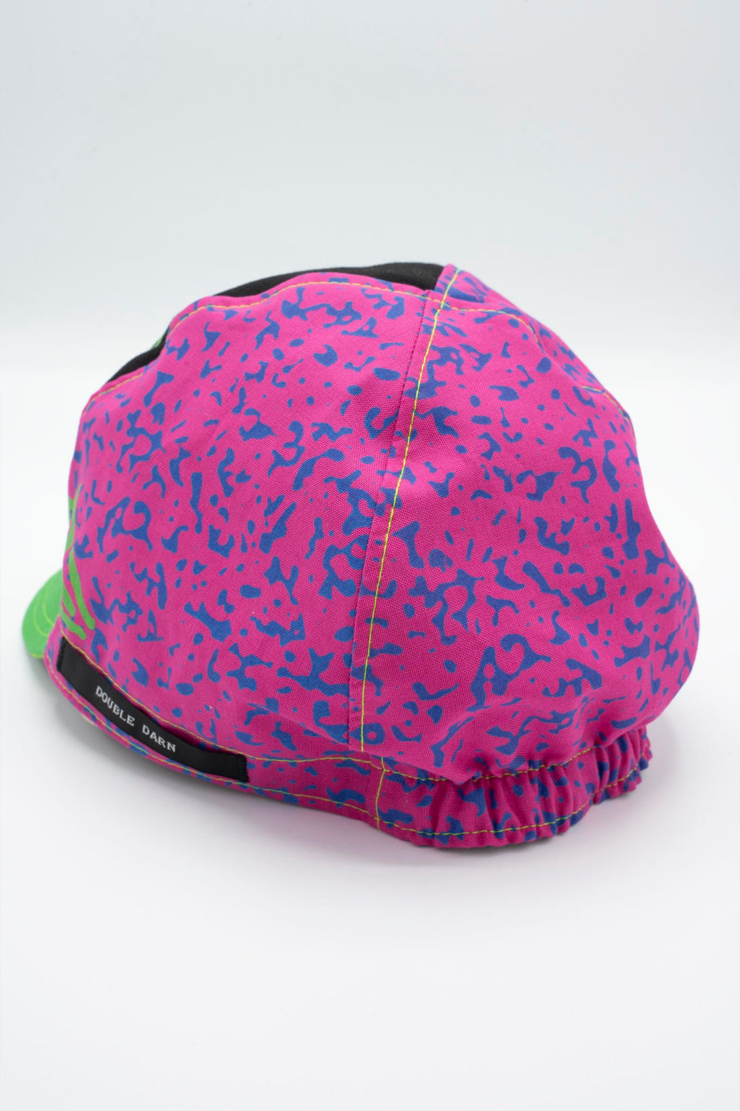 The Athletic Super Tuff Strawberry Cycling Cap is a vibrant, unstructured 3-panel cap featuring a bold strawberry design. Crafted in the Portland, OR, by Double Darn, this cap offers a comfortable fit.