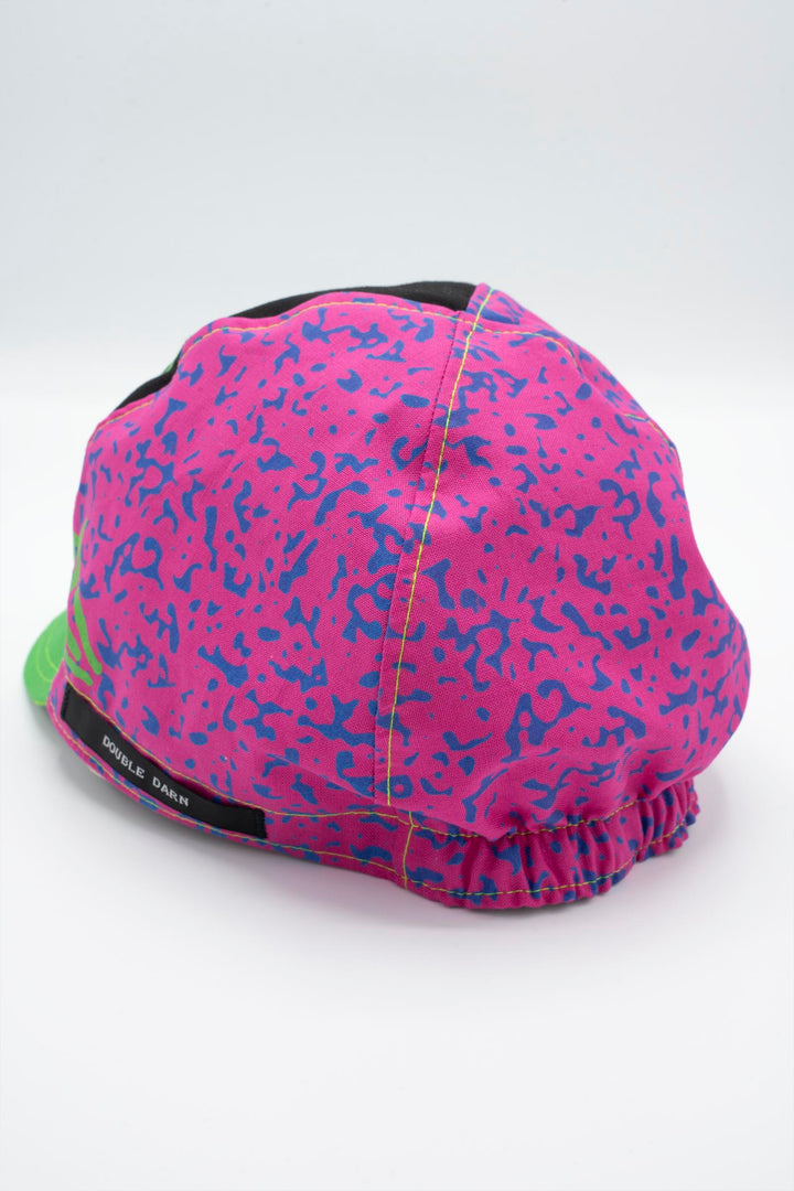 The Athletic Super Tuff Strawberry Cycling Cap is a vibrant, unstructured 3-panel cap featuring a bold strawberry design. Crafted in the Portland, OR, by Double Darn, this cap offers a comfortable fit.