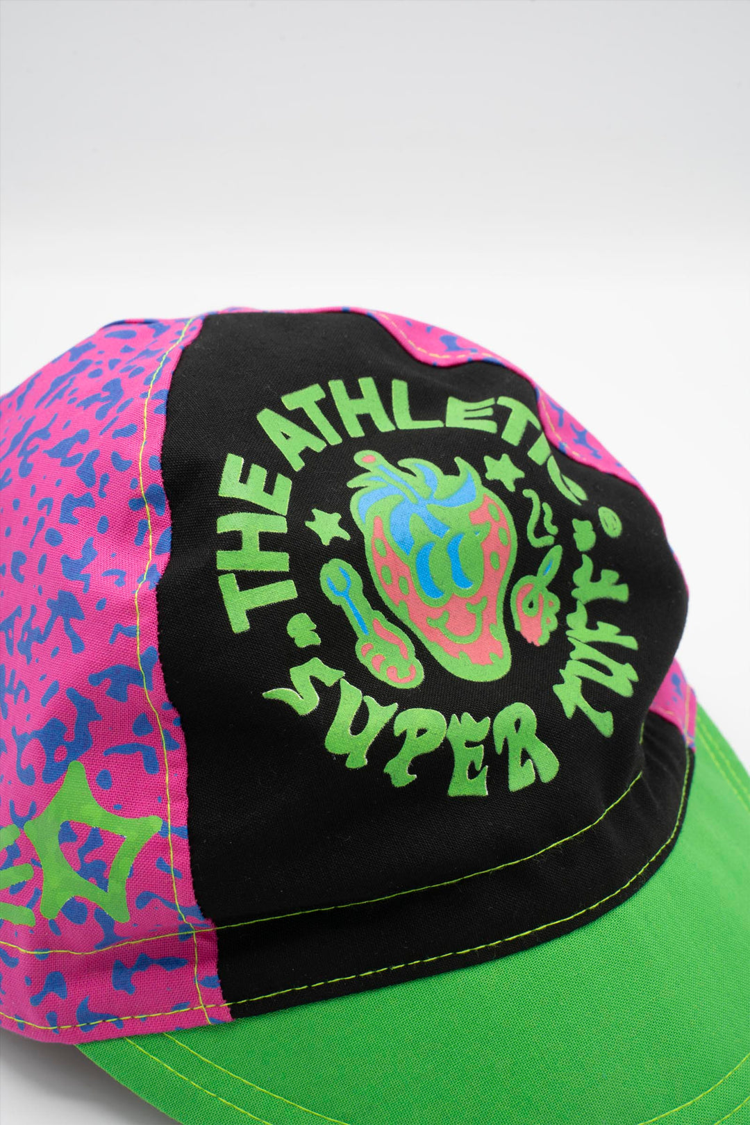 The Athletic Super Tuff Strawberry Cycling Cap is a vibrant, unstructured 3-panel cap featuring a bold strawberry design. Crafted in the Portland, OR, by Double Darn, this cap offers a comfortable fit.