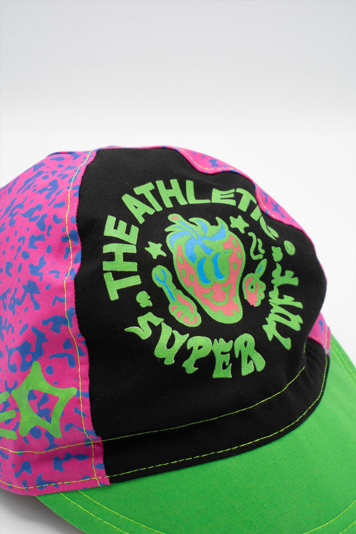 The Athletic Super Tuff Strawberry Cycling Cap is a vibrant, unstructured 3-panel cap featuring a bold strawberry design. Crafted in the Portland, OR, by Double Darn, this cap offers a comfortable fit.