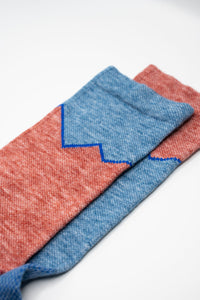 Mismatched red and blue wool socks for running and cycling