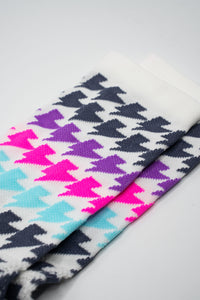 White sock with black, purple, teal, pink lightning bolts for running and cycling