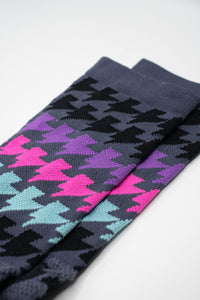 Grey sock with black, purple, teal, pink lightning bolts for running and cycling