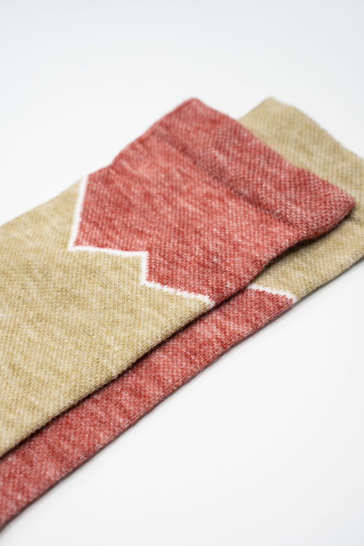 The Athletic x Golden Saddle Cyclery Elevation Lightweight Wool Blend Socks are a collaboration between The Athletic Community and Golden Saddle Cyclery. These mismatched socks feature a lightweight wool and synthetic blend, ensuring your feet stay dry and comfortable whether you're trekking up into the mountains or rocking kicks around town. Made in the United States with love.