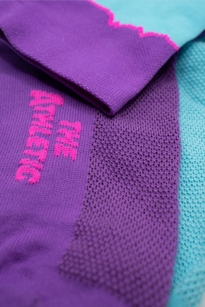 The Elevation Socks – Hood to Coast Edition are designed to commemorate the iconic Hood to Coast Relay, featuring a design that mirrors the elevation profile of the course from Wy'East to the Pacific Ocean. These socks are crafted for versatility, suitable for running, walking, hiking, or cycling. They offer a medium compression cuff for support and are made from a blend of 60% nylon, 39% recycled polyester, and 1% Lycra, ensuring both comfort and durability. Machine washable for easy care