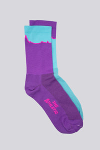 Mismatched socks with teal and purple colors for running or cycling