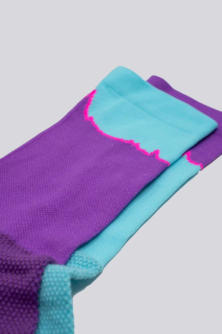The Elevation Socks – Hood to Coast Edition are designed to commemorate the iconic Hood to Coast Relay, featuring a design that mirrors the elevation profile of the course from Wy'East to the Pacific Ocean. These socks are crafted for versatility, suitable for running, walking, hiking, or cycling. They offer a medium compression cuff for support and are made from a blend of 60% nylon, 39% recycled polyester, and 1% Lycra, ensuring both comfort and durability. Machine washable for easy care