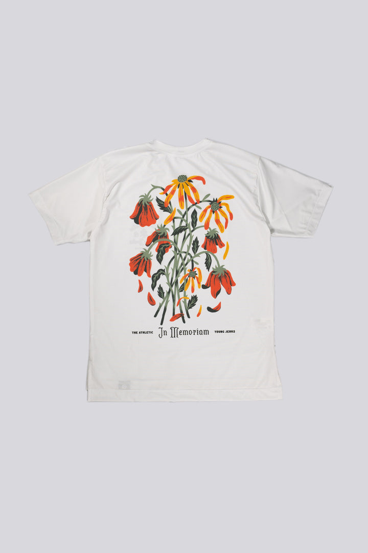 The Women's In Memoriam Short Sleeve Tech Tee is a bright white, short-sleeve shirt featuring a chest decal and a flower design across the back. Ideal for running, cycling, or cross-training, this tee pairs beautifully with black El Sol socks or gold Death Palm designs. Crafted in California from Italian fabrics by Endo Customs, it offers both style and performance for active individuals