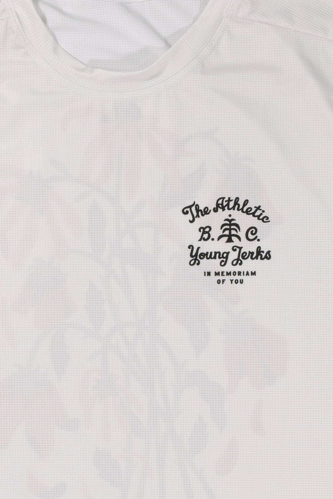 The Women's In Memoriam Short Sleeve Tech Tee is a bright white, short-sleeve shirt featuring a chest decal and a flower design across the back. Ideal for running, cycling, or cross-training, this tee pairs beautifully with black El Sol socks or gold Death Palm designs. Crafted in California from Italian fabrics by Endo Customs, it offers both style and performance for active individuals