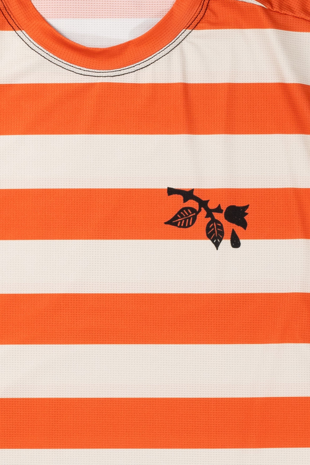 The Women's Waldo Short Sleeve Tech Tee is a versatile performance shirt designed for activities like running, cycling, and cross-training. Crafted in California from Italian-engineered fabrics, it features a lightweight, breathable design with a split side seam at the hem to accommodate lower body movement. This timeless striped tee, adorned with a black rose on the upper left chest, offers both style and functionality for active individuals