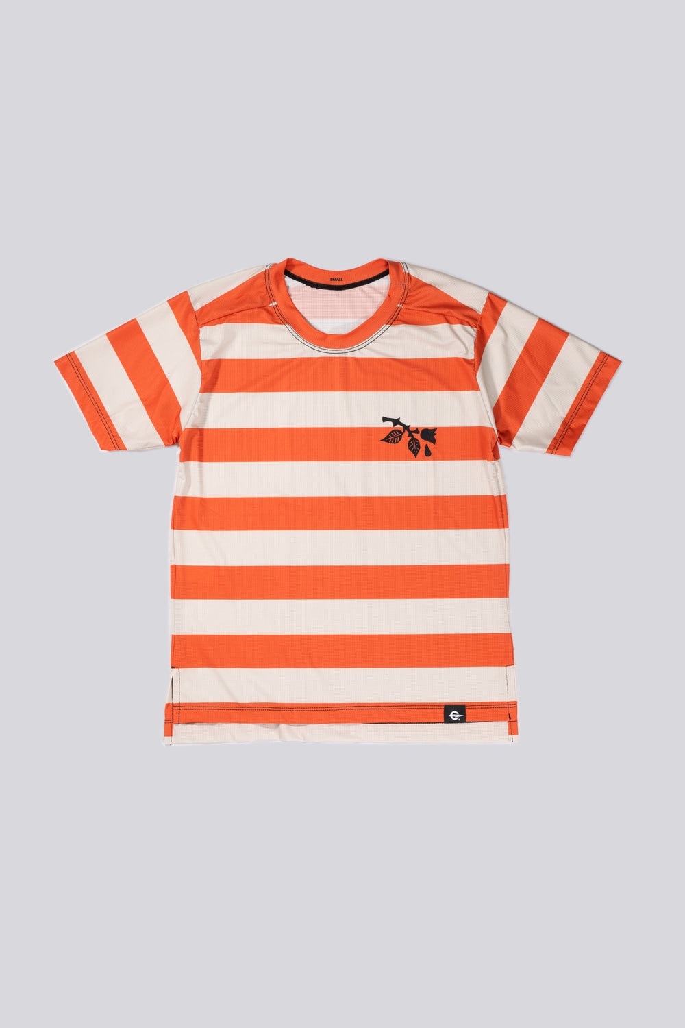 The Women's Waldo Short Sleeve Tech Tee is a versatile performance shirt designed for activities like running, cycling, and cross-training. Crafted in California from Italian-engineered fabrics, it features a lightweight, breathable design with a split side seam at the hem to accommodate lower body movement. This timeless striped tee, adorned with a black rose on the upper left chest, offers both style and functionality for active individuals