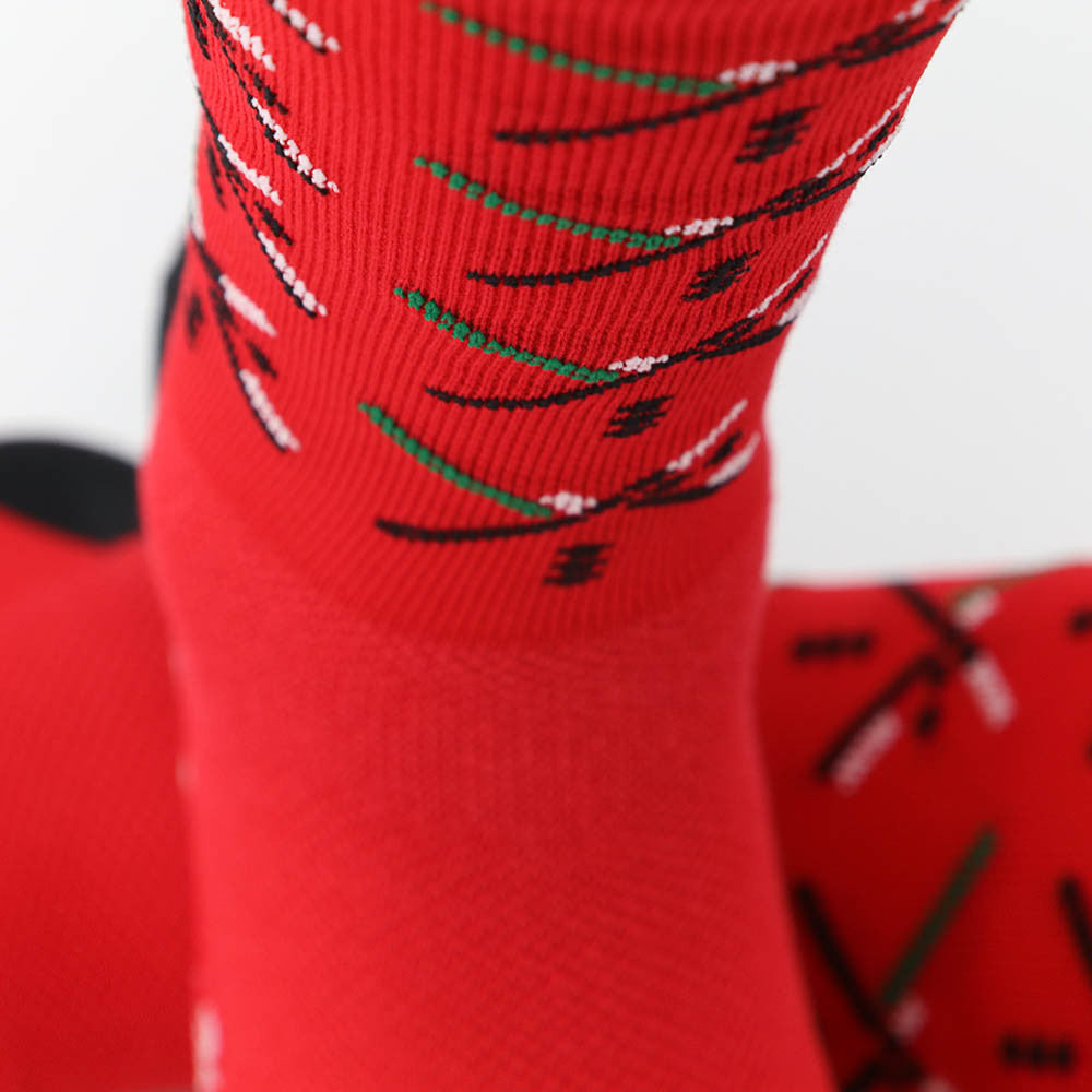 The PDX Futbol Fan Sock Home Red is a tribute to Portland's local soccer team, featuring the iconic PDX Airport carpet design in red, green, and black. Ideal for cycling, running, and cross-training, these socks combine style and performance. Made in the USA with recycled fibers, they offer both durability and sustainability