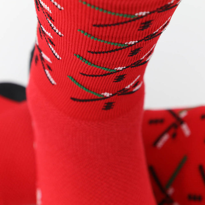 The PDX Futbol Fan Sock Home Red is a tribute to Portland's local soccer team, featuring the iconic PDX Airport carpet design in red, green, and black. Ideal for cycling, running, and cross-training, these socks combine style and performance. Made in the USA with recycled fibers, they offer both durability and sustainability