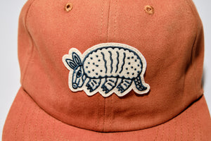 Rust colored embroidered Armadillo hat. The Athletic embroidered in the back
