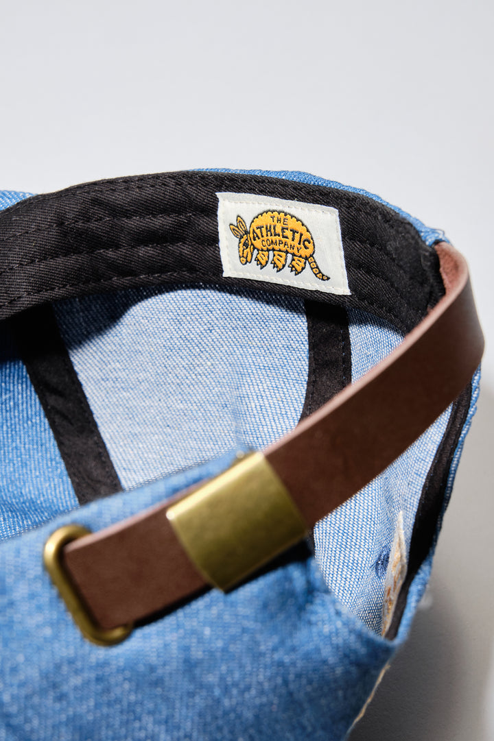 The Athletic Wavy A Denim Hat is a 100% cotton denim cap featuring the embroidered "Wavy A" logo, symbolizing The Athletic's blend of past and future. Designed in collaboration with Young Jerks, this hat offers a timeless, denim aesthetic suitable for various off-bike activities
