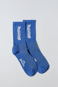 Blue socks with "Grateful" text.