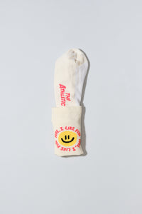 Smiley face socks with "Sure, I like fun" caption. Socks are oatmeal colored..